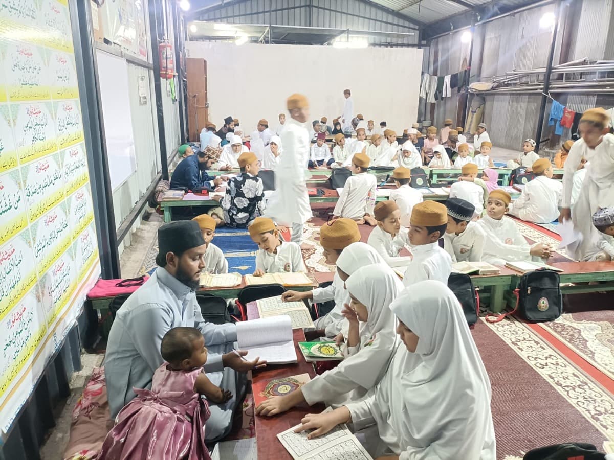Students reading the Quran with their teacher