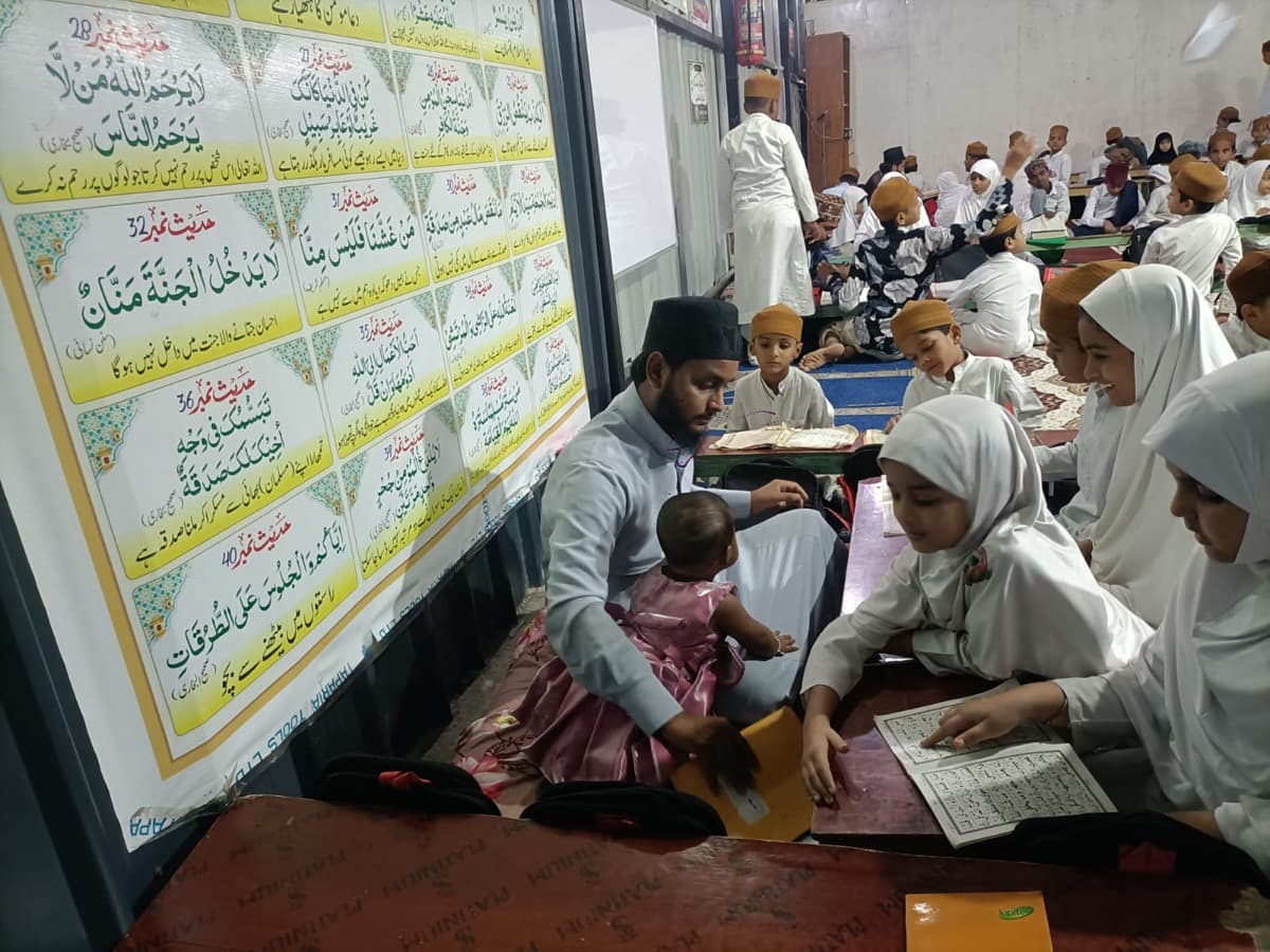 Students reading the Quran with their teacher