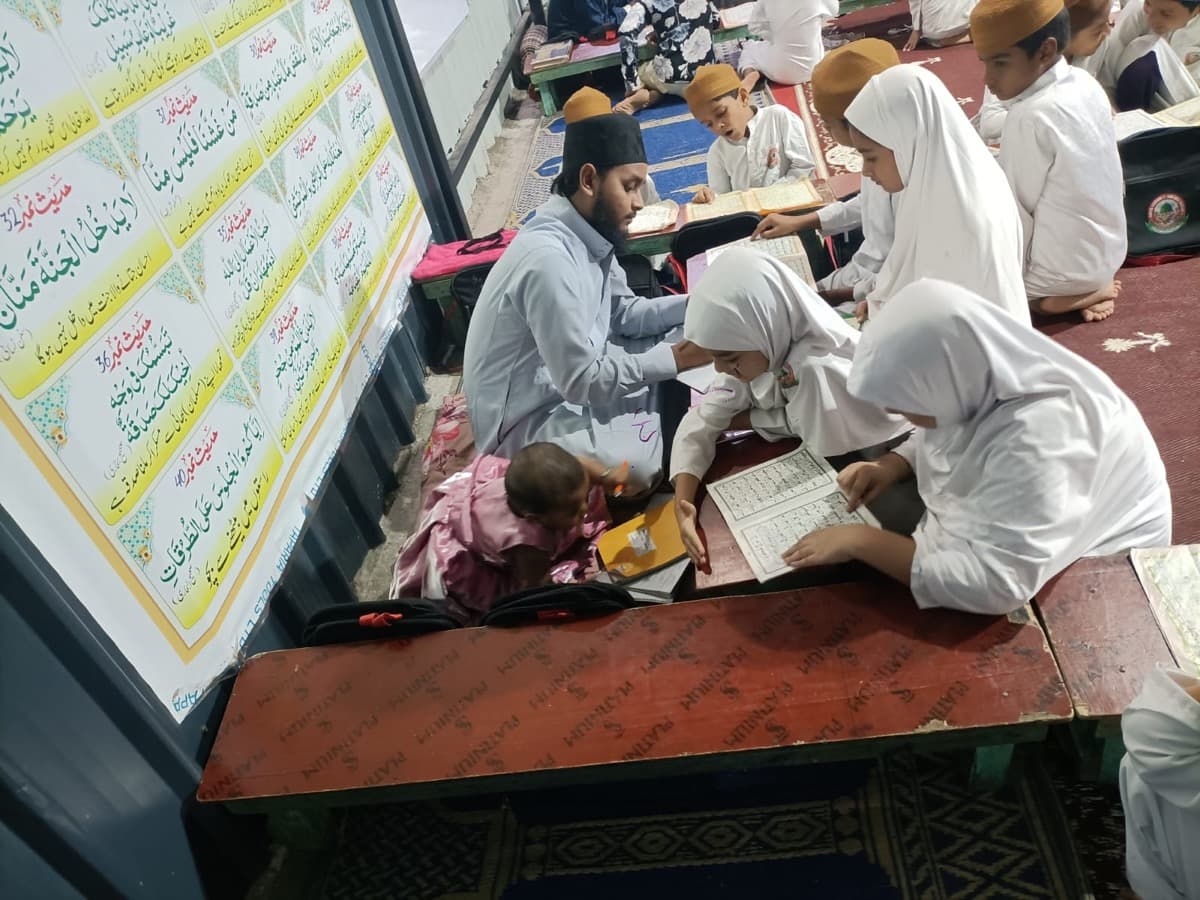 Students reading the Quran with their teacher