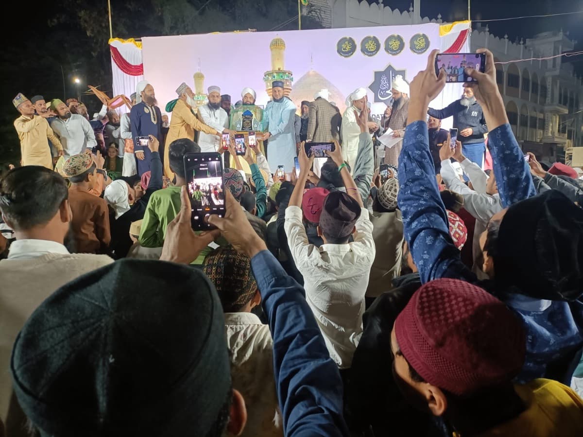 Scholars on stage at a gathering