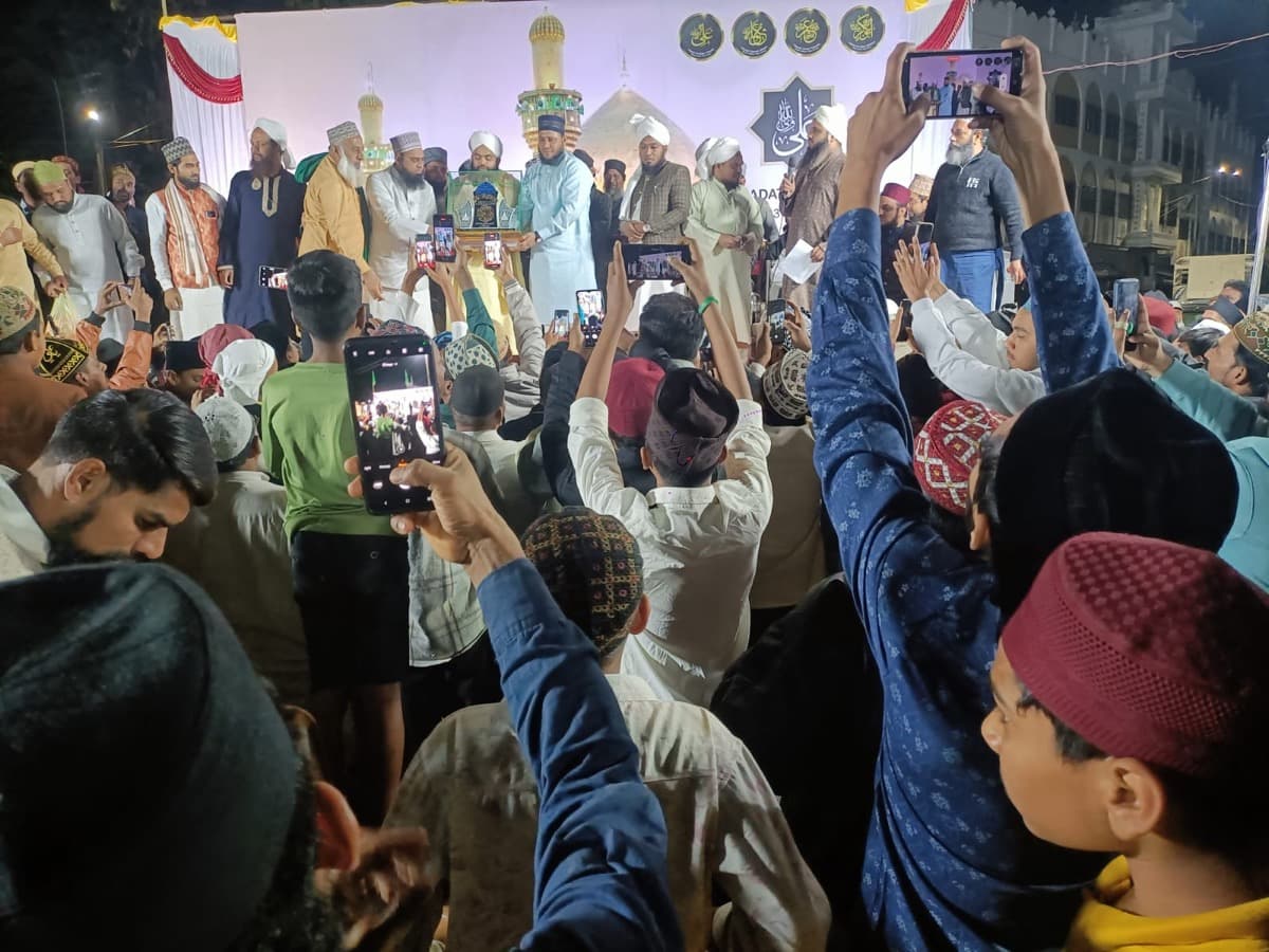 Scholars on stage at a gathering