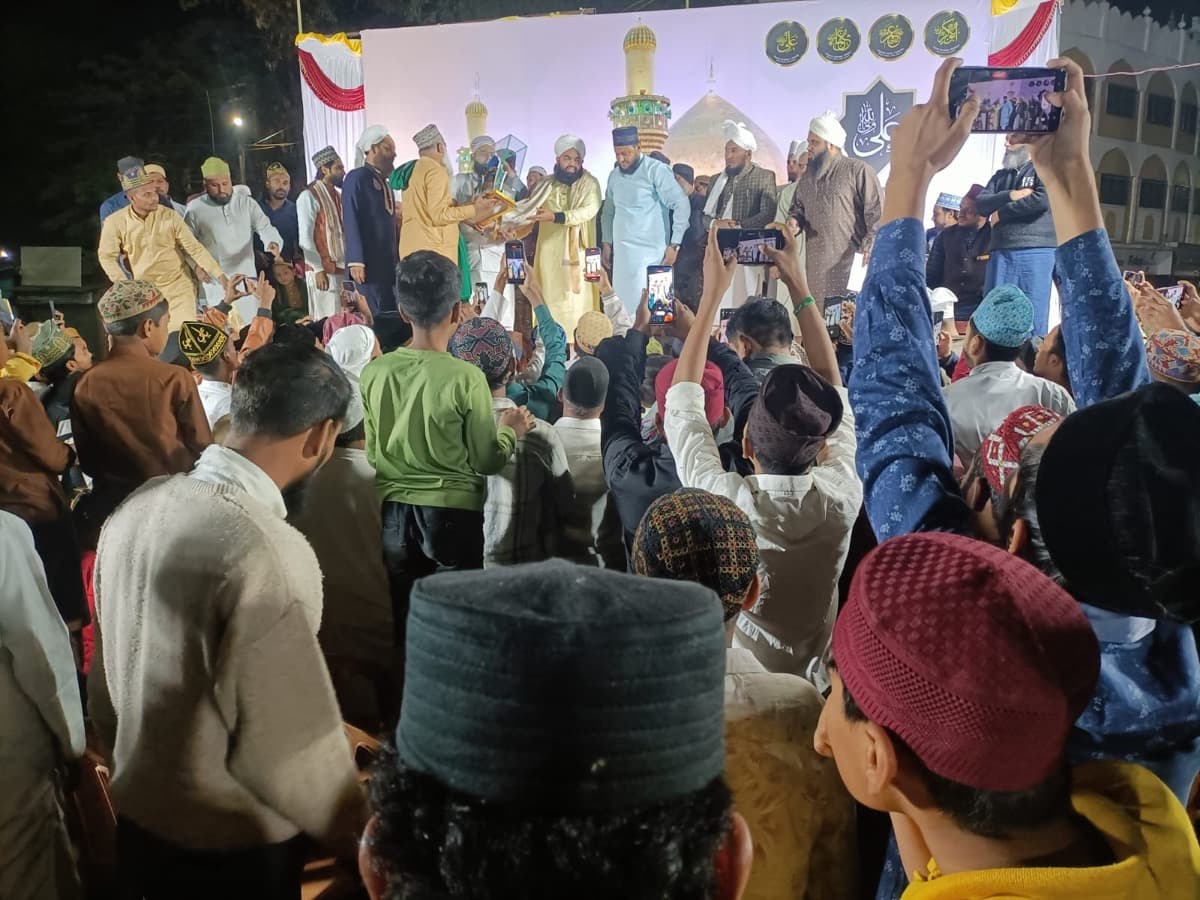 Scholars on stage at a gathering