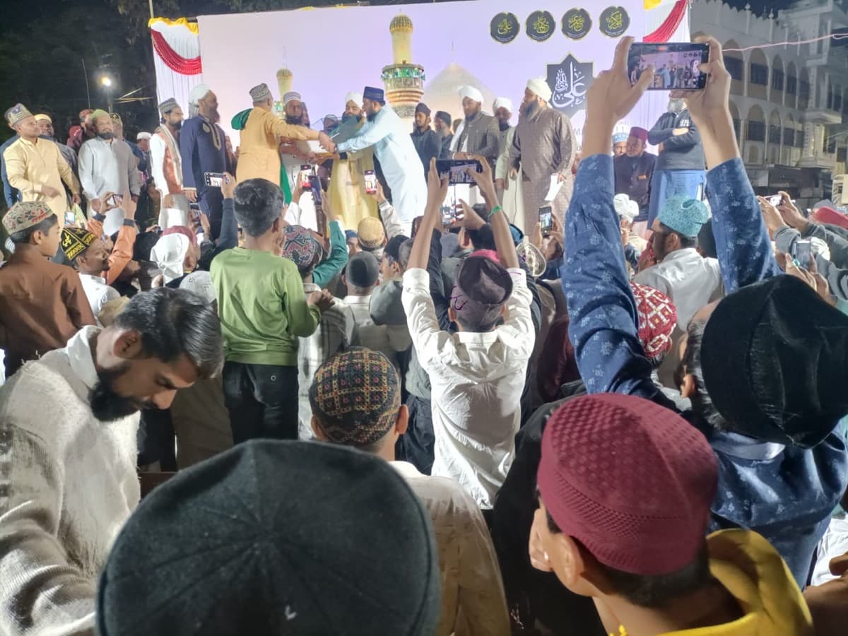 Scholars on stage at a gathering
